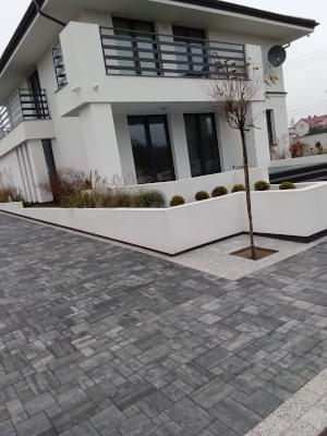 Grafitowo-biała kostka brukowa ułożona na podwórku przed domem